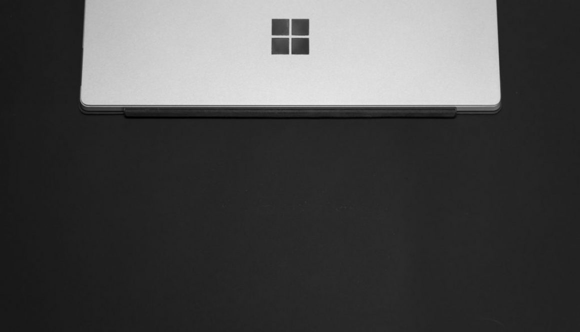 A stock photo shows a silver Microsoft Surface on a black tablecloth
