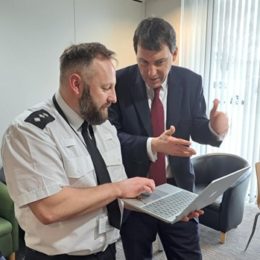 The minister is being given a demo of the DVPN app by Ch Insp Dan Tillett