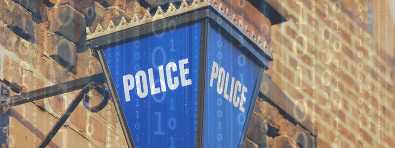 Police lantern on a building with code overlay.