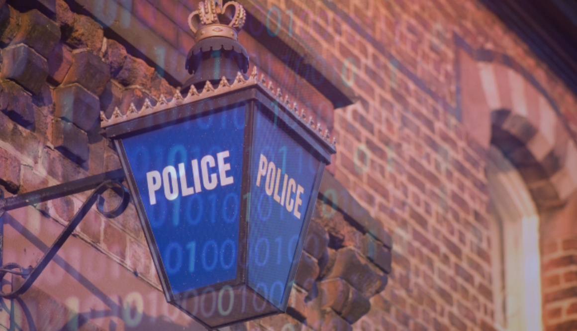 Police lantern outside red brick building.